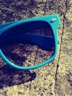 Gafas de sol azules sobre piedra