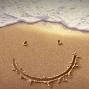 Cara sonriente en la arena